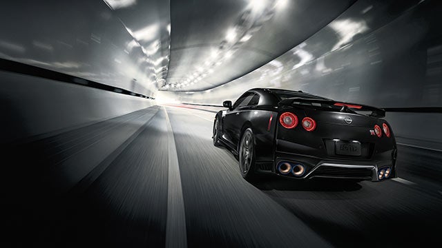 2023 Nissan GT-R seen from behind driving through a tunnel | Tony Serra Highland Nissan in Highland MI